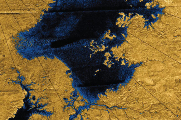 Radar image of a lake taken from high above Titan's surface shows liquid areas as dark blue and land areas as dark yellow.