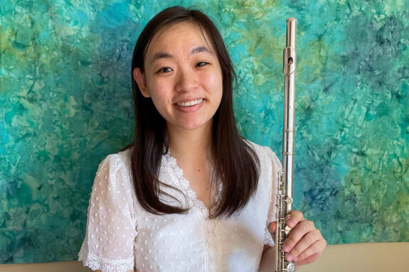 A photo portrait of Phoebe Lin holding a flute.
