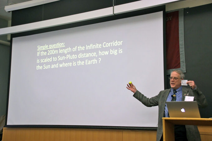 Richard Binzel holds a golf ball to illustrate the sun's size at 1:30 billion scale