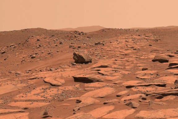 Photo of the brown, rocky, clay Mars surface.