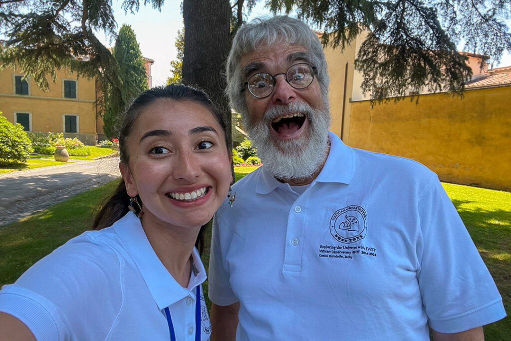 A selfie of Guy Consolmagno, making an overly excited face, with a beaming Isabella Marcias.