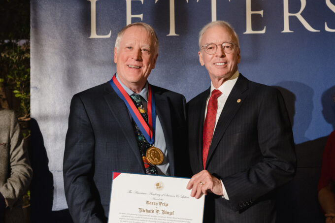 Richard Binzel standing next to Donald W. Landry and receiving a plaque award for the Barry Prize.