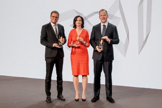 Sara Seager stands with Markus Rex and Wolfgang Busch, holding their NOMIS Awards.