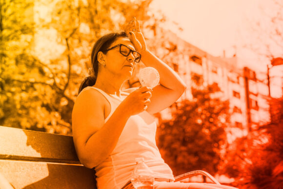 Overheated person with fan.