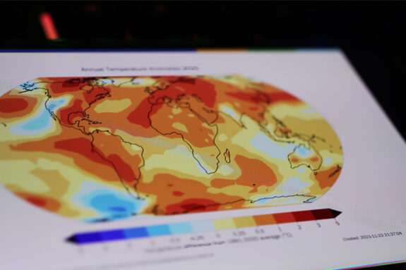 A smartphone screen showing a World Meteorological Organization state of global climate warming graph.
