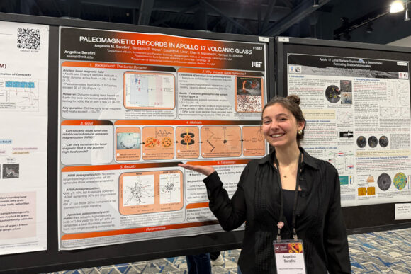 Angelina Serafini showing off her scientific poster, titled 