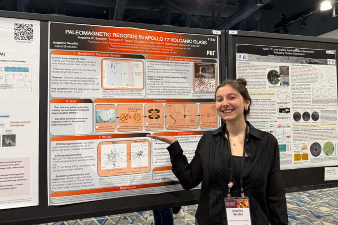 Angelina Serafini showing off her scientific poster, titled 