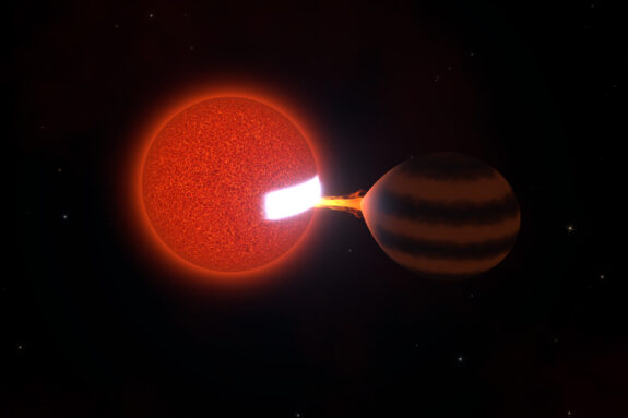 A red sphere, left, sucks energy out of a brown sphere, causing a patch on the red sphere to glow white hot.